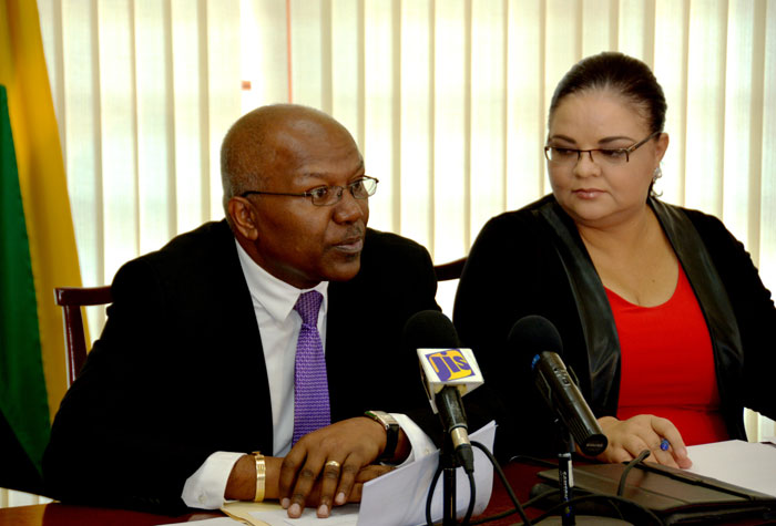 Minister without Portfolio in the Ministry of Transport, Works and Housing,  Hon. Dr. Morais Guy (left), announces that a new legislation to empower the Administrator General to transfer property to secondary beneficiaries, in now before Parliament. Occasion  was a Jamaica House media briefing in Montego bay on February 5. At right is Minister with responsibility for Information, Senator the Hon. Sandrea Falconer.