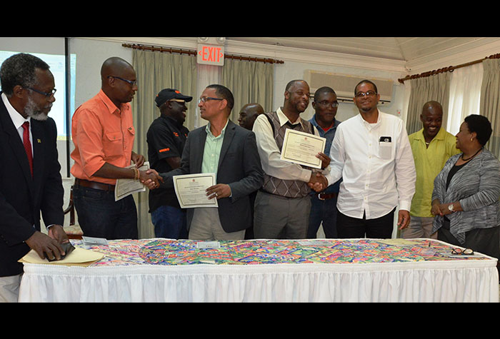 Political Ombudsman, Donna Parchment Brown (right), and Custos Rotulorum for
Hanover, Hon. Dr. David Stair (left), oversee completion of the formalities
during Friday's (February 12) signing of the Political Code of Conduct by
the four candidates contesting the February 25 General Elections in Hanover,
at the Tryall Hotel. The candidates (from 2nd left, foreground) are: State
Minister for Water, Land, Environment, and Climate Change, Hon. Ian Hayles,
for the People's National Party (PNP), and the Jamaica Labour Party's (JLP)
Brian Wallace (JLP), who will vie for the Western Hanover constituency; and
Wynter McIntosh (PNP) and Dave Brown (JLP), who will contest  Eastern
Hanover. Looking on, in the background, are supporters of both candidates.
