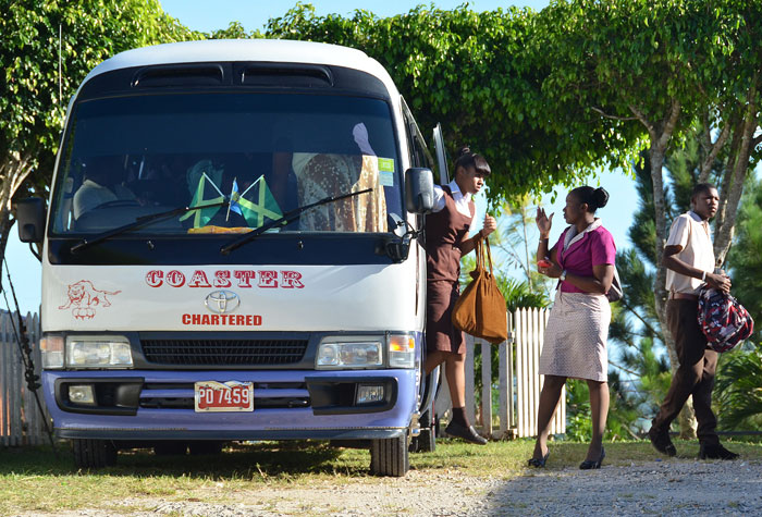 Students and staff of Holmwood Technical High School in Manchester, disembarking one of two buses contracted by the institution’s management to provide transportation services for students.