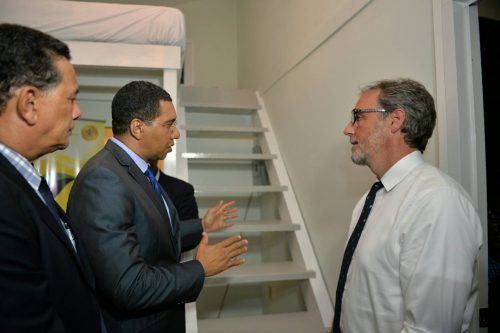 Prime Minister, the Most Hon. Andrew Holness (centre), converses with Co-Founder of Tiny House Enterprises, Andrew Morrison (right), during a tour of a ‘tiny house’, which was on display at the opening of the Build Expo and Conference at the Montego Bay Convention Centre in St. James on June 9. Looking on is Mayor of Montego Bay, His Worship Homer Davis.