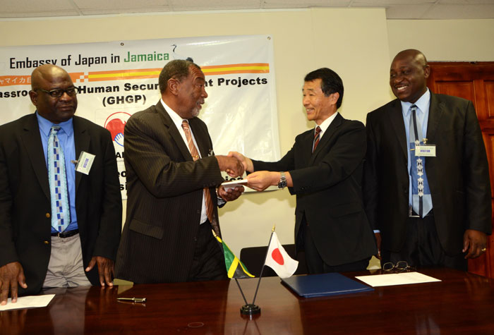 Charge d’Affairs, Embassy of Japan in Jamaica, Koji Tomita (2nd right), presents and Westmoreland Parish Council Chairman and Savanna-la-Mar Mayor, Councillor Bertel Moore (2nd left), with a copy of the $8 million (US$81,010) grant agreement for Government of Japan’s provision of two ambulances and two fire trucks to the Council, following Monday’s (March 24) signing ceremony at the Embassy’s New Kingston offices. The units’ provision is being facilitated under Japan’s Grant Assistance for Grass-Roots and Human Security Project (GGP) in partnership with the Society for the Promotion of Japanese Diplomacy (SPJD). Looking on are: Councillors for the Westmoreland Parish Council’s Savanna-la-Mar and Bethel Town Divisions respectively, Milton Miles (left); and Danree Delancy, who is also Savanna-la-Mar’s Deputy Mayor.
