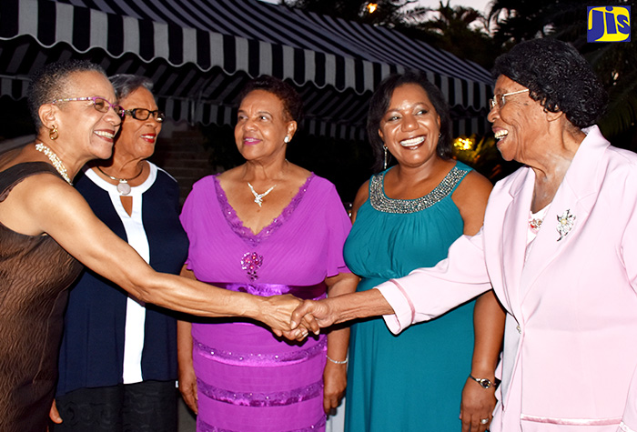 Master of Ceremonies, Fae Ellington (left), welcomes former Superintendent and Director of the Jamaica Christian Boys’ Home, Frances Christina Knight (right), at the Child Development Agency (CDA) 2016 Residential Child Care Facilities Dinner, held on December 8 at the Terra Nova Hotel in Kingston. Others (from left) are: Founder and Administrator of the West Haven Children’s Home, Gloria Sybil Veira; Founder of Reddie’s Place of Safety, E. Clover Ena Reddie-Brown; and Chief Executive Officer of the CDA, Rosalee Gage-Grey. 