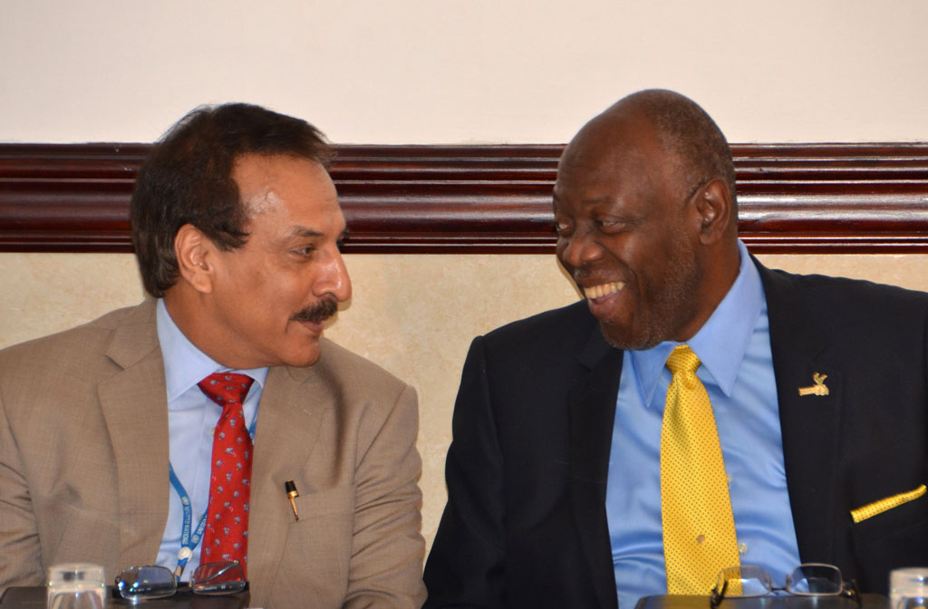 Minister of Health, Hon. Dr. Fenton Ferguson (right), converses with UN Resident Co-ordinator, Dr. Arun Kashyap, during the opening ceremony of the Global Validation and Lessons Learned Workshop on Gender Equality in the Context of HIV/AIDS, held at the Jamaica Pegasus Hotel in New Kingston on July 30.