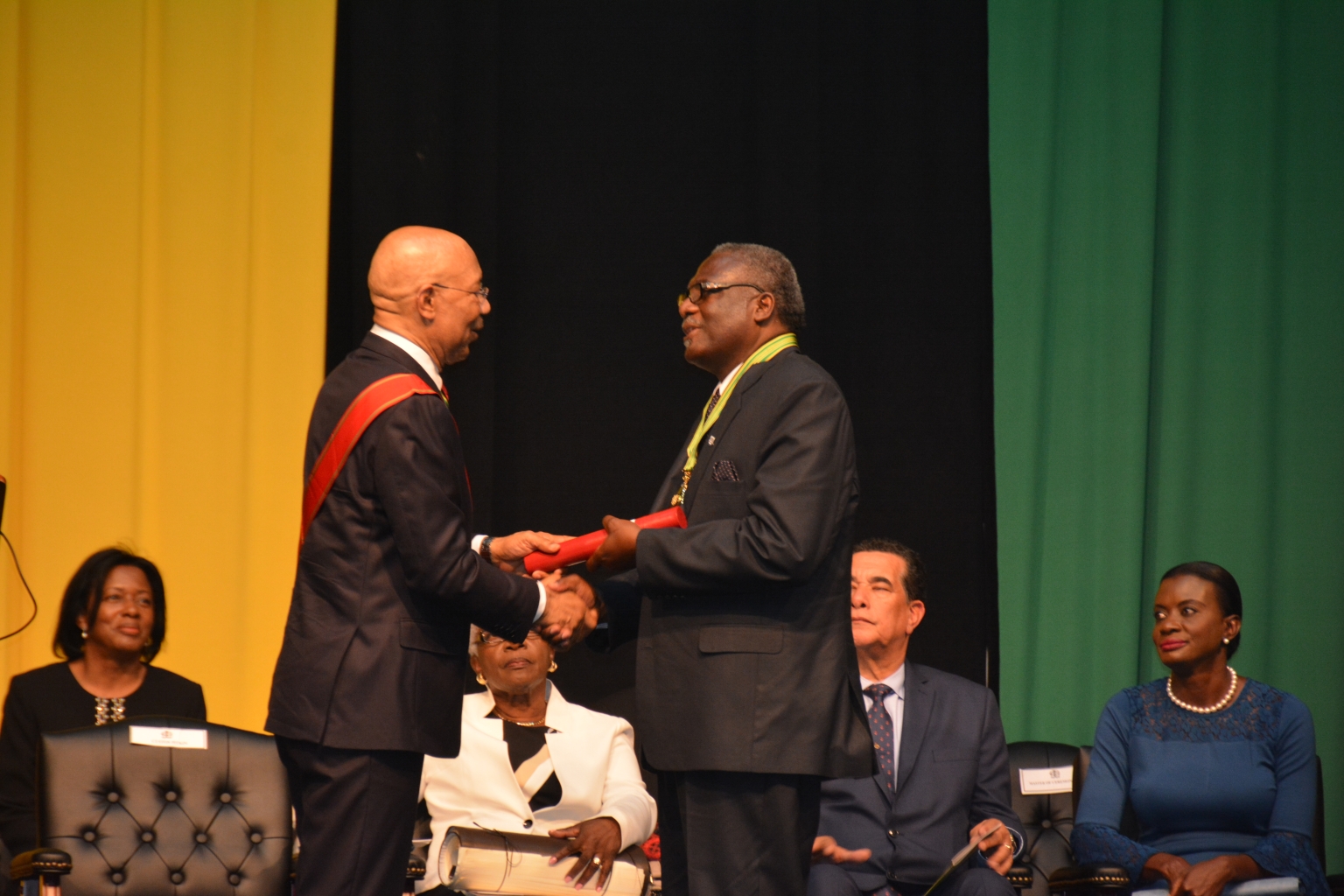 Governor-General, His Excellency the Most Hon. Sir Patrick Allen (left), presents the magistrate's roll for St. James o new Custos of the parish, Bishop Conrad Pitkin, at the installtion ceremony held on April 5 at the Montego Bay Convention Centre.