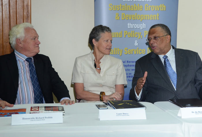 Finance and Planning Minister, Dr. the Hon. Peter Phillips (right), converses with (from left): Asian Development Bank (ADB) Representative, Hon. Richard Prebble, and Pacific Private Sector Development Specialist, Laure Darcy, during a seminar for officials of local State-Owned Enterprises (SOEs), at the New Kingston Conference Centre, on Wednesday (July 22). The seminar formed part of the itinerary for Mr. Prebble, Ms. Darcy and other members of the ADB delegation, who are in Jamaica on a working visit, from July 20 to 23.  