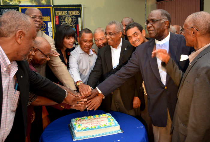 Prime Minister the Most Hon. Portia Simpson Miller (fourth left), assists  several past presidents of the Kiwanis Club of North St. Andrew to cut the 40th anniversary cake on Thursday (March 20), at the Police Officers’ Club in St. Andrew.  Mrs. Simpson Miller was the guest  speaker at the ceremony.
