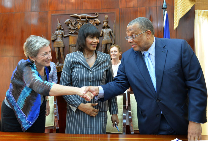 Prime Minister, the Most Hon Portia Simpson Miller (centre); looks on as Minister of Finance and Planning, Hon. Dr. Peter Phillips (right); greets Head of the European Union (EU) Delegation in Jamaica, Her Excellency Paola Amadei (left). Occasion was the signing ceremony between Jamaica and the EU, for grant funding of $11.5 billion, held at Jamaica House on May 9 to mark Europe Day.