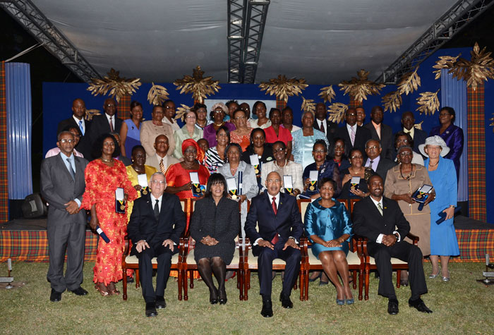 The nation’s leaders, headed by Governor-General, His Excellency  the Most Hon. Sir Patrick Allen (seated centre) and Lady Allen (second right); Prime Minister, the Most Hon. Portia Simpson Miller (second left); Education Minister, Hon. Rev. Ronald Thwaites (left); and Jamaica Teachers’ Association President (JTA), Clayton Hall (right), pose with the 40 educators who received the Prime Minister’s Medal of Appreciation for Service to Education on June 9, at Jamaica House.