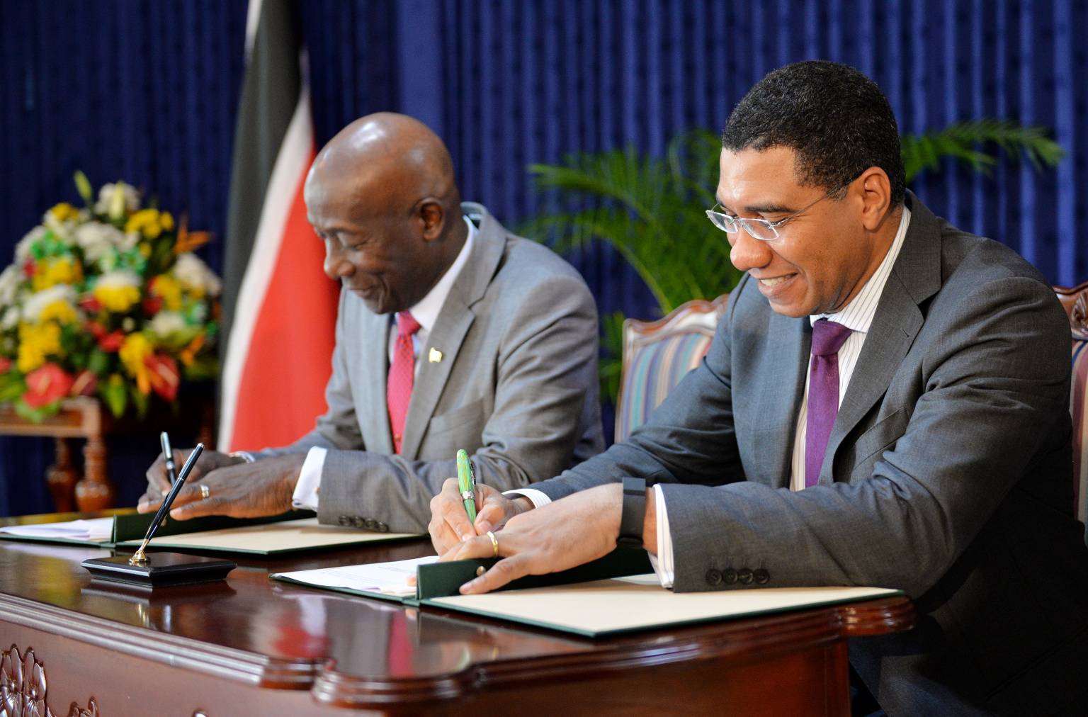 Prime Minister, the Most Hon. Andrew Holness (right), and Prime Minister of the Republic of Trinidad and Tobago, Dr. the Hon. Keith Rowley, display signed communiqué which details the results of bilateral discussions between the two Prime Ministers during Dr. Rowley’s official visit to Jamaica from July 17 to 21. The joint communiqué was signed ahead of a press conference at the Office of the Prime Minister on July 21.