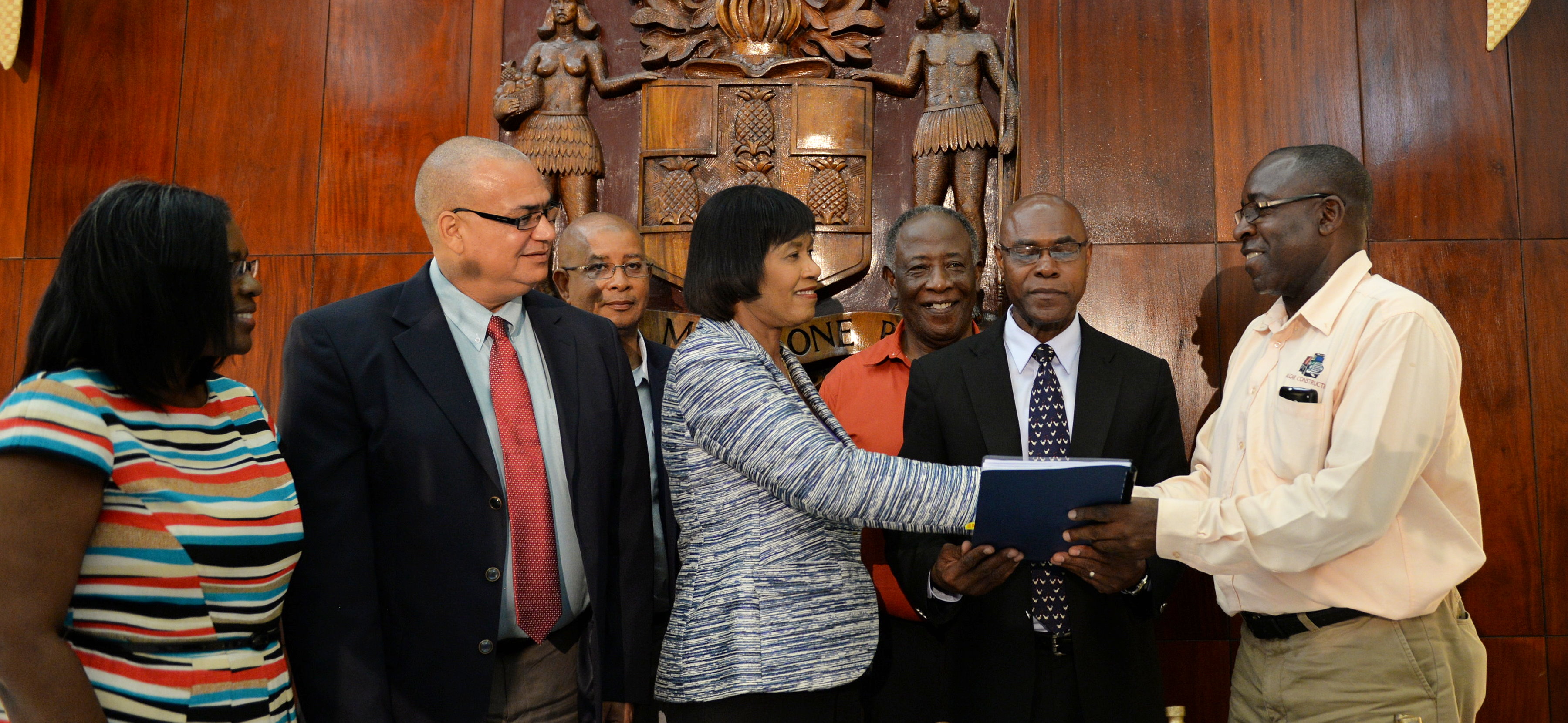 Prime Minister, the Most Hon. Portia Simpson Miller (centre), shakes hands with Managing Director of Alcar Construction and Haulage Company, Junior Leslie (right), at the contract signing for the construction of a box culvert in the farming community of Wood Hall, St Catherine, at Jamaica House on July 27. Observing are (from left): Permanent Secretary in the Ministry of Transport, Works and Housing, Audrey Sewell; Minister of State in the Ministry of Transport, Works and Housing, Hon. Richard Azan; Mayor of Spanish Town, Norman Scott; Deputy Mayor and Councilor for the Ginger Ridge Division, Ralston Wilson; and Chief Executive Officer of the National Works Agency (NWA), Everton Hunter. 