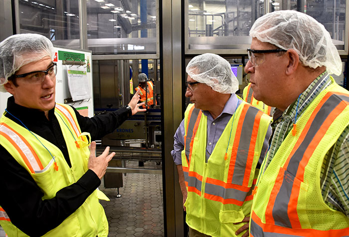 Industry, Commerce, Agriculture and Fisheries Minister, Hon. Audley Shaw (right), and Jamaica Manufacturerss Association (JMA) President, Metry Seaga (centre), are updated on Red Stripe/Heineken Jamaica’s new $2.16-billion (€14-million) state-of-the art Line 8 production facility at the company’s brewery on Spanish Town Road, Kingston, by Managing Director, Ricardo Nuncio, during a tour of the plant on Friday (April 6).