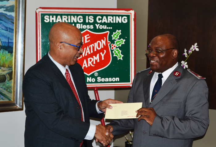 Salvation Army's Divisional Commander, Major Edward Lyons (right), receives a cheque for $500,000 from Scotia Bank's District Vice President, Steve Distant. Occasion was the launch of the Salvation Army Western Jamaica Division’s Christmas Kettle Appeal on November 13,  at the Scotia Bank Financial Centre in Montego Bay.