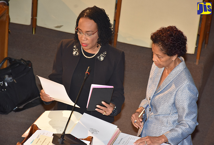 Newly appointed Opposition Senator, Attorney-at-Law, Donna Scott-Mottley (left), takes the Oath of Allegiance during the swearing-in ceremony at today’s (October 20) sitting of the Senate at Gordon House. Administering the proceedings is Clerk to the Houses of Parliament, Heather Cooke. Mrs. Donna Scott-Mottley has also been appointed Leader of Opposition Business in the Upper House.