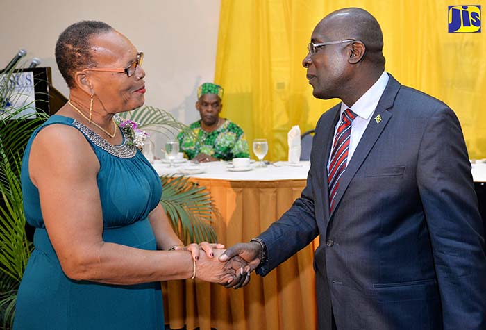 Minister of Education, Youth and Information, Senator the Hon. Ruel Reid (right),  greets retired Principal of Lyssons Primary in Morant Bay, Ena Barclay. Occasion was a Recognition Ceremony for 23 retired educators from the parishes of Portland, St. Thomas and St. Mary held on September 19 at The Jamaica Pegasus hotel in New Kingston.