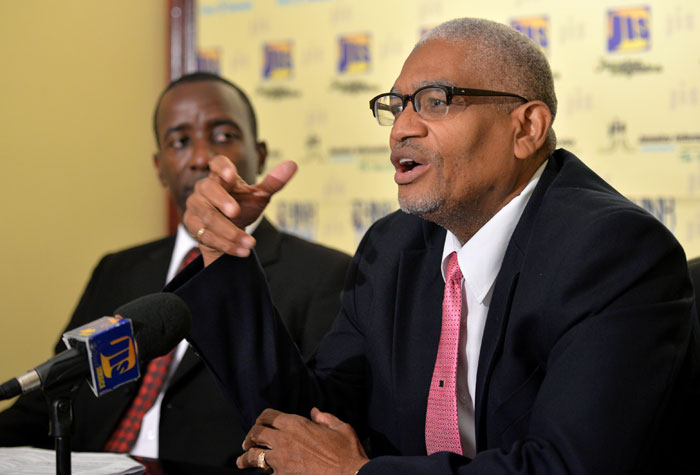 Executive Director of the Tourism Enhancement Fund (TEF), Clyde Harrison, highlights major programmes being undertaken by the entity, during a JIS Think Tank on June 2. Looking on is Director of Projects at TEF, Christopher Miller.