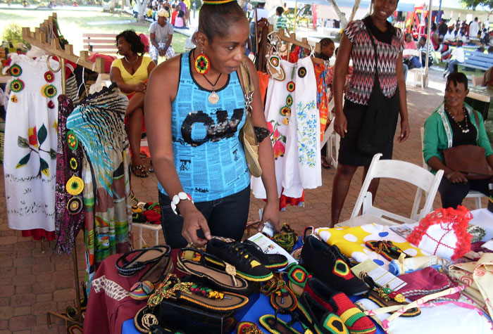 Entrepreneur Dawn Bartley makes final adjustments to display items in her booth, at the Trench Town Trade and Investment Fair held recently, at Emancipation Park, New Kingston.