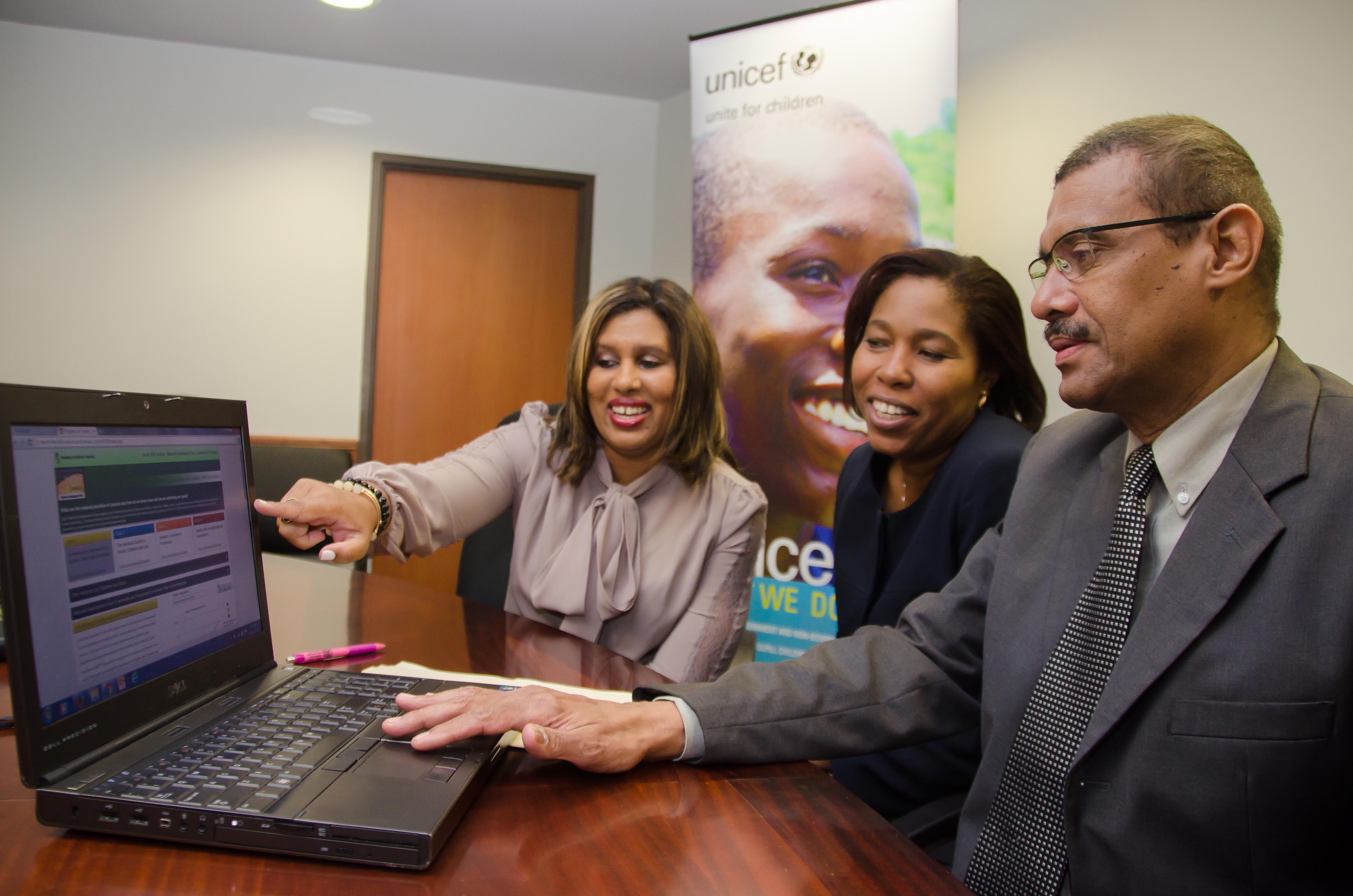 Deputy Director General, Planning Institute of Jamaica (PIOJ), Richard Lumsden (right), views the online dashboard of indicators for the Vision 2030 Jamaica – National Development Plan, at the PIOJ’s offices in New Kingston, on Monday, November 30. Also viewing the platform, from left, are: Programme Director, Vision 2030 Secretariat, Elizabeth Emanuel; and United Nations Children’s Fund (UNICEF)Monitoring and Evaluation Specialist in Jamaica, Donneth Edmonson.