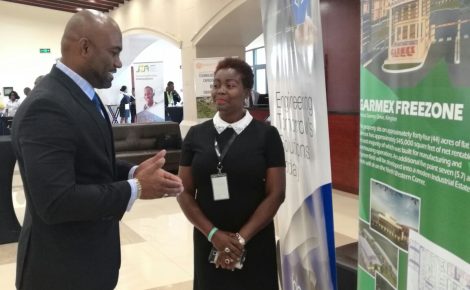Minister of Science, Energy and Technology, Dr. the Hon. Andrew Wheatley (Left), speaks with President of the Business Process Industry Association of Jamaica (BPIAJ), Gloria Henry, on the final day of the two-day Outsource2Jamaica inaugural Symposium and Expo held at the Montego Bay Convention from April 12 to 13.