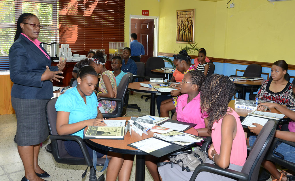 Director, Public Service Capability Development, Management Institute for National Development (MIND), Ann-Marie Smith (left), addresses participants in the FEMPower Leadership Programme, during the opening ceremony for the course today (July 15), at the MIND Kingston campus. 