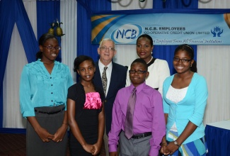 Minister of Education, Hon. Rev. Ronald Thwaites (back row),  with recipients of the NCB Employees Co-operative Credit Union Limited 's 2013 Treasure Chest Solid Goal Grade Six Achievement Test (GSAT) scholarship award, during a ceremony  held at the Hotel Four Seasons in Kingston on August 7. The awardees (from left) are: Monique Barrett, Angel Baker, Jonathan Scott, and Kia Cole. Also pictured in the back row is President of the credit union, Josephine Bennett-Darmand.