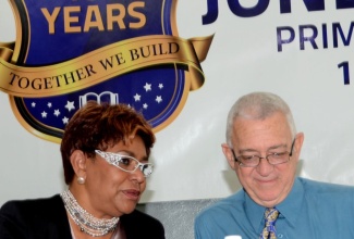 Minister of Education, Hon. Rev. Ronald Thwaites (right), converses with Board Chairman, Jones Town Primary School, Maria Jones, during a special forum on primary education held today (Oct. 10), at the Jones Town Primary School in Kingston.