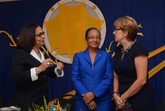 Minister of Labour and Social Security, Hon. Shahine Robinson (left), in conversation with Permanent Secretary, Colette Roberts Risden (centre) and World Bank Country Manager, Galina Sotirova, at the launch of PATH’s Youth Ambassador Programme on November 9, at Mona Visitors’ Lodge, in Kingston.