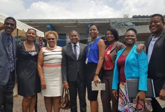 State Minister in the Ministry of Education, Youth and Information, Hon. Floyd Green (fourth left),  with Olivia Leigh Campbell, of Sutherland Global, and senior members of staff of Community Colleges,   at the Career and Information Fair, held at  Knox Community College’s Mandeville Campus in Manchester, on April 26.