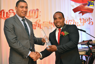 Prime Minister, the Most Hon. Andrew Holness (left), receives the Elsa Leo-Rhynie Towers Hall Award from Student Services and Development Manager, Elsa Leo-Rhynie Hall, University of the West Indies (UWI), Mona, Bertram Anderson. Occasion was the Hall’s annual banquet at The Jamaica Pegasus hotel on March 23. The award is presented annually to a distinguished past student of UWI.