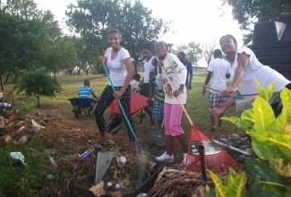 Jamaica 4-H clubbites participate in cleaning up duties at the organisation’s annual camp held from July 5 to 12 in Rose Hall, St. Catherine.