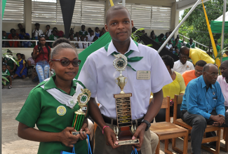 Jamaica 4-H Clubs’ Girl of the Year, Shevone Smith (left) and Boy of the Year, Patrick Morris, display their trophies at the National Achievement Day Expo held recently, at the Denbigh Showground in May Pen, Clarendon.