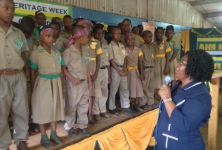 Principal of the Kitson Town All Age School in St. Catherine, Nerica Powell-Hay (right), addresses a group of newly installed students leaders, during a ceremony held at the institution yesterday (Oct. 16), which was also used to recognize the contributions of the country’s National Heroes.