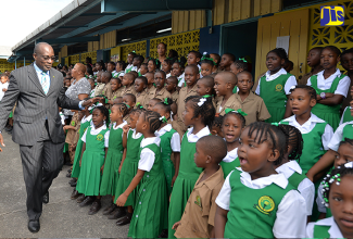 : Minister of Education, Youth and Information, Senator the Hon. Ruel Reid (left), greets students of Mona Heights Primary School during his visit on September 5. The Minister also  officially opened a new sanitation facility, which was partially funded by the Ministry. 