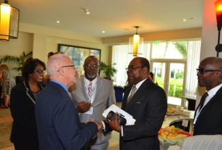 Minister of Education, Rev. the Hon. Ronald Thwaites (2nd left), exchanges pleasantries with Member of Parliament for East Central St. James, Edmund Bartlett (2nd right), at yesterday’s (July 11) opening ceremony of the 12th Annual Conference of the Association of Caribbean Higher Education Administrators (ACHEA), at the Hilton Rose Hall Resort and Spa in Montego Bay, St. James yesterday (July 11). Looking on are President of ACHEA, Dr. Kofi
Nkrumah-Young (centre) and Immediate Past President of ACHEA, Clement Iton (right).