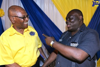 Permanent Secretary in the Ministry of Industry, Commerce, Agriculture and Fisheries, Donovan Stanberry (right), has a light moment with Managing Director, St. Jago Farm and Hardware Supplies Limited, O’Brien Johnson, at  a ceremony for the rebranding of St. Jago Farm and Hardware Supplies Limited at the Caymanas Golf and Country Club, St. Catherine, on April 19.