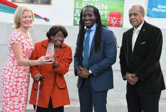 Minister of State in the Ministry of Culture, Gender, Entertainment and Sport, the Honourable Alando Terrelonge (second right) with Dr Lucille Buchannan, Founder, Special Olympics Jamaica (second left); Mary Davis, CEO, Special Olympics International and Ali McNab, Chairman, Special Olympics Jamaica. Dr. Buchannan was presented with an award in recognition of her role as a founding member of the Special Olympics movement in Jamaica, yesterday (April 10) at the Special Olympics Multipurpose Court at Independence Park.