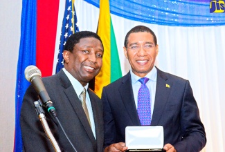 Prime Minister, the Most Hon. Andrew Holness (right), receives the Keys to Broward County from County Commissioner, Dale Holness, at the 10th annual  Grand Gala and Awards Ceremony of the Jamaican-American Bar Association (JABA), held at the Westin Hotel in Fort Lauderdale, Florida, on November 18. 