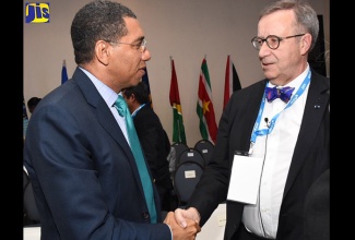 Prime Minister, the Most Hon. Andrew Holness (left), greets former President of the Republic of Estonia, Toomas Hendrik Ilves, during the 7th Annual Inter-American Development Bank Caribbean Governors' Conference at The Jamaica Pegasus hotel, New Kingston, on Tuesday (February 27).

