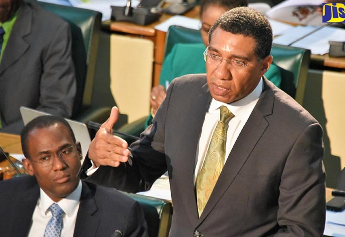 Prime Minister, the Most Hon. Andrew Holness (right), addressing the House of Representatives on April 3. At left is Minister of Finance and the Public Service, Dr the Hon. Nigel Clarke.