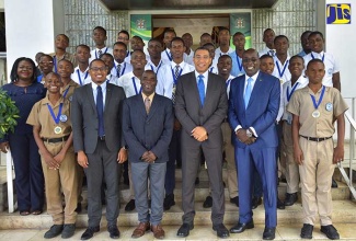 Prime Minister, the Most Hon. Andrew Holness (front, centre); State Minister in the Ministry of Education, Youth and Information, Hon. Floyd Green (second left); Principal of Bog Walk High School, Patrick Phillips (third left); and Minister of Education, Youth and Information, Senator the Hon. Ruel Reid (second right), with students and administrators of the Bog Walk High School, who are participants in the institution’s ‘Boys Big-Up Programme’, at Jamaica House on April 25.  