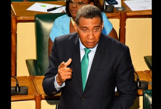 Prime Minister, the Most Hon. Andrew Holness (at podium), emphasises a point while making his contribution to the 2018 Budget Debate in the House of Representatives on Tuesday (March 20). Pictured in the background, is the Prime Minister’s wife and Member of Parliament for East Rural St. Andrew, the Most Hon. Juliet Holness.