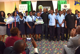 Minister of Science, Energy and Technology, Hon. Andrew Wheatley (centre); Chairman of the Universal Service Fund (USF), Robert Lawrence (fourth right, front row); and Chief Executive Officer, Suzette Buchanan (left, front row) with the All Together Sing 2017 Champion, Knox High School Choir, during a performance following the launch of the USF’s Technology Advancement Programme (TAP) at The Knutsford Court Hotel in Kingston on December 15.
