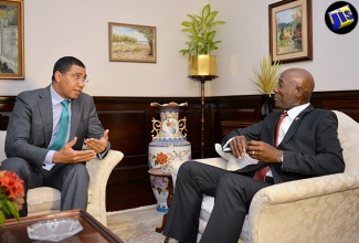 Prime Minister, the Most Hon. Andrew Holness (left), in dialogue with Prime Minister of the Republic of Trinidad and Tobago, Dr. the Hon. Keith Rowley, during a reception hosted in Dr. Rowley’s honour at Vale Royal on July 20.  (File)