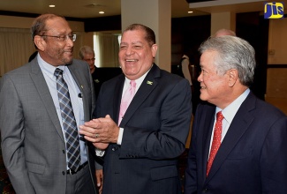 Industry, Commerce, Agriculture and Fisheries Minister, Hon. Audley Shaw (centre) shares a light moment with President of the Private Sector Organisation of Jamaica (PSOJ), Howard Mitchell (left); and Chairman and Chief Executive Officer (CEO) of National Baking Company, Gary Hendrickson, at the press launch of the Bold Ones Manufacturing Initiative for Expo Jamaica 2018, at The Jamaica Pegasus hotel in New Kingston on April 10. 