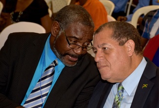 Finance and Public Service Minister, Hon. Audley Shaw (right), converses with University of Technology (UTech) Lecturer, Lloyd Wint, during the institution’s Money, Banking and Finance Conference held at the school’s main campus in Papine, St. Andrew, on Wednesday, April 13. 