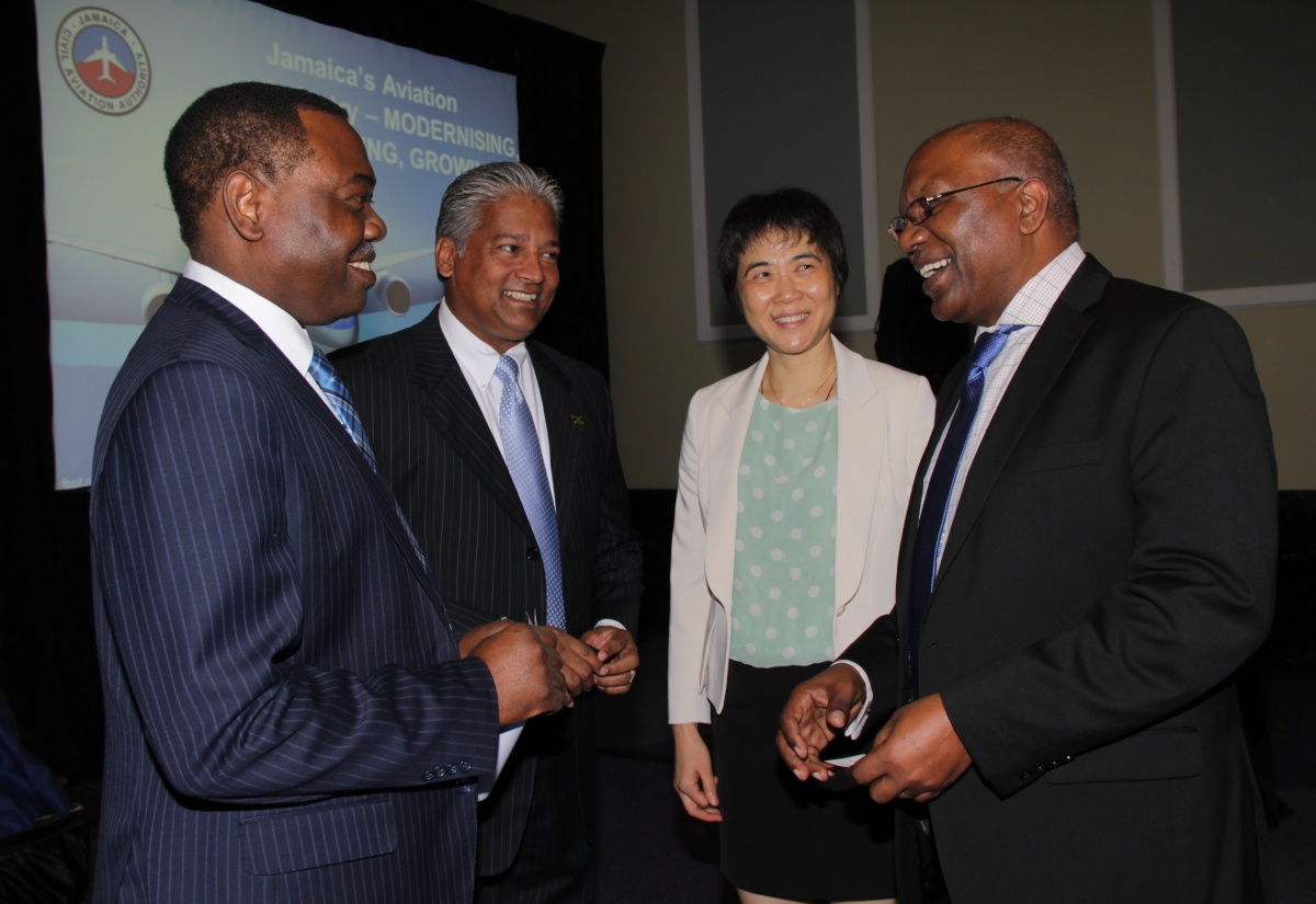 Minister without Portfolio in the Ministry of Transport, Works and Housing, Hon. Dr. Morais Guy (right), converses with (from left): President of the International Civil Aviation Organization (ICAO), Dr. Olumuyiwa Benard Aliu; Director General of the Jamaica Civil Aviation Authority (JCAA), Nari Williams-Singh; and ICAO Secretary General, Dr. Fang Liu. Occasion was the meeting of  the ICAO Council at the Iberostar Hotel in Lilliput, St. James earlier this week.