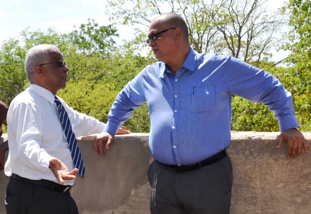 State Minister for Transport, Works and Housing, Hon. Richard Azan (right), in discussion with Councillor for the Pedro Plains Division of the St. Elizabeth Parish Council, Jeremy Palmer, during a tour of projects under the Jamaica Emergency Employment Programme (JEEP) in the parish, on Thursday, April 16. 