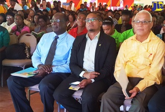 Minister of Education, Youth and Information, Senator the Hon. Ruel Reid (left); State Minister in the Ministry, Hon. Floyd Green (centre) and Member of Parliament for St. Elizabeth North-East, Mr. Evon Redman, watch a performance by infant-school children at the Early Childhood Commission Certification Fair for Region Five, held at Everglades Centre, in Black River, St Elizabeth, on February 17.