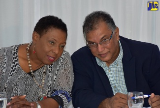 Vice President of the Jamaica Olympic Association (JOA), Vishu Tollan (right), in  discussion with Minister of Culture, Gender, Entertainment and Sport, Hon. Olivia Grange, at a press conference at the Spanish Court Hotel, in Kingston, on October 11. 