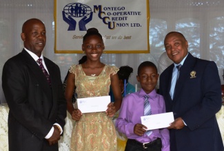 Bayley Hay scholars, Shannia McDowells (2nd left) and Calvin Lindo (2nd right) are presented with their awards by President of  Montego Co-operative Credit Union, Lambert Johnson (left) and General Manager, Ornell Bedasse. The presentation took place at a luncheon held at Day’O Plantation Restaurant in Montego Bay, on July 13.
