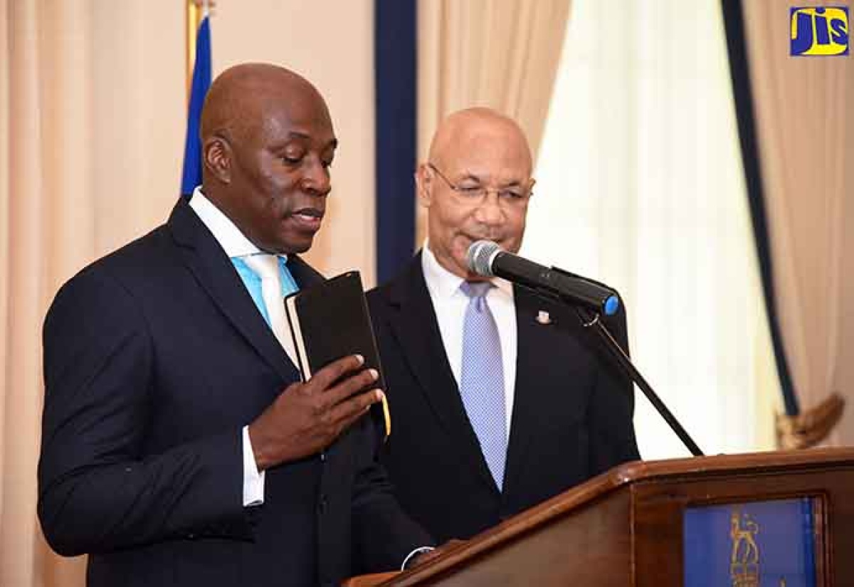 Governor-General, His Excellency the Most Hon. Sir Patrick Allen (right), observes as Hon. Justice Bryan Sykes takes the Oath of Office during a ceremony at King’s House today (February 1).  Justice Sykes has been appointed to act as Chief Justice.